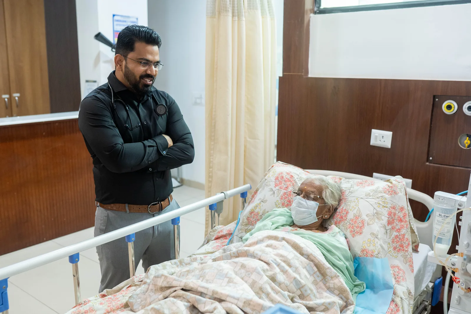 Doctor making rounds with patient on dialysis bed