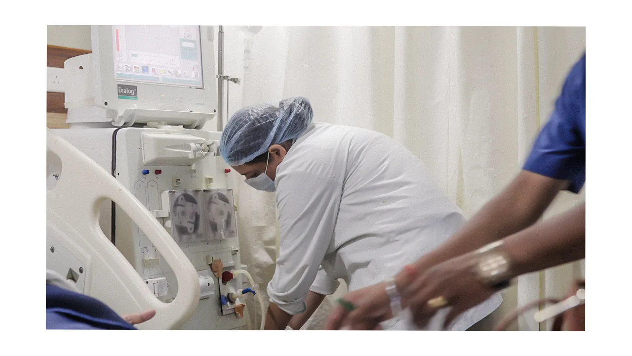 Clinical staff setting up dialysis machine